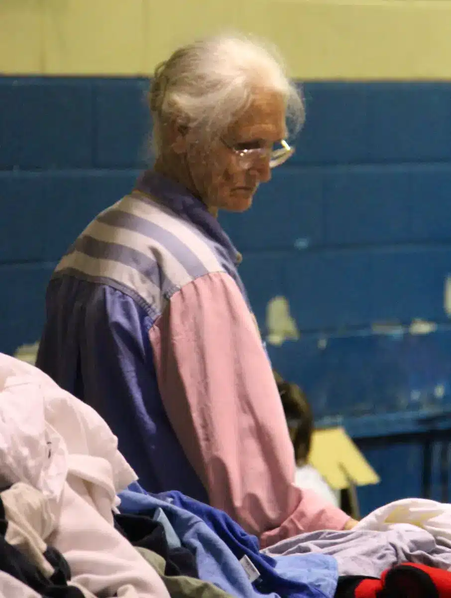 A community member at a clothing distribution