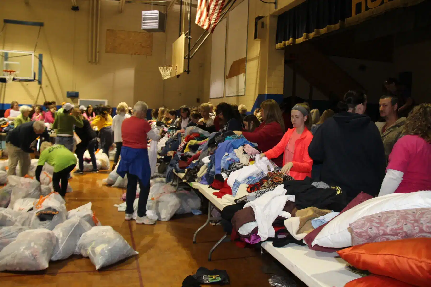 People choosing clothing at a distribution
