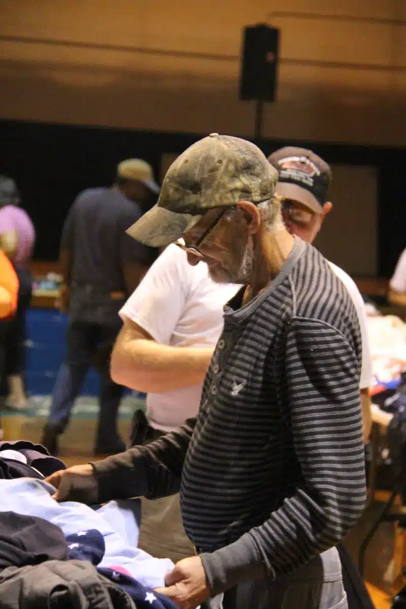 A volunteer at a clothing distribution