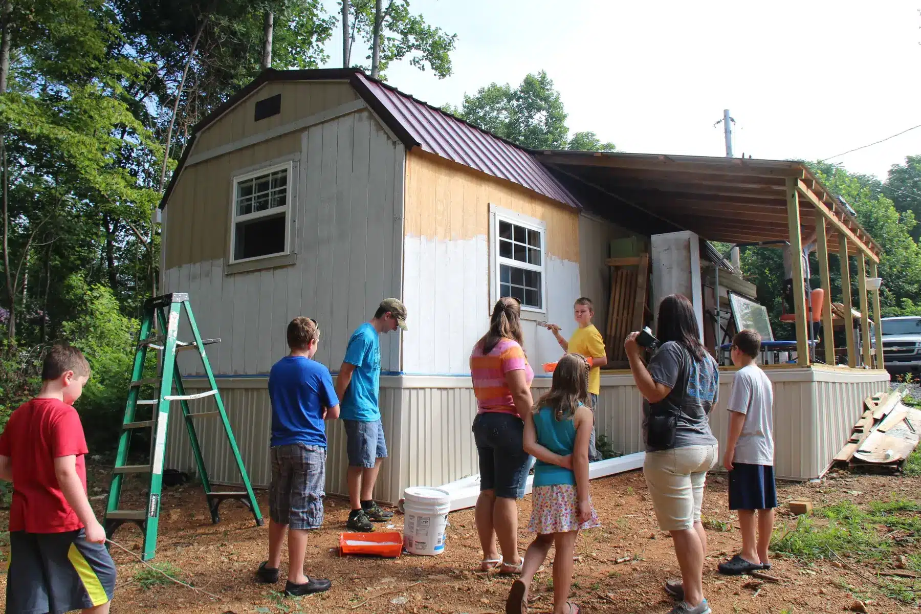Young volunteers painting during a home repair project