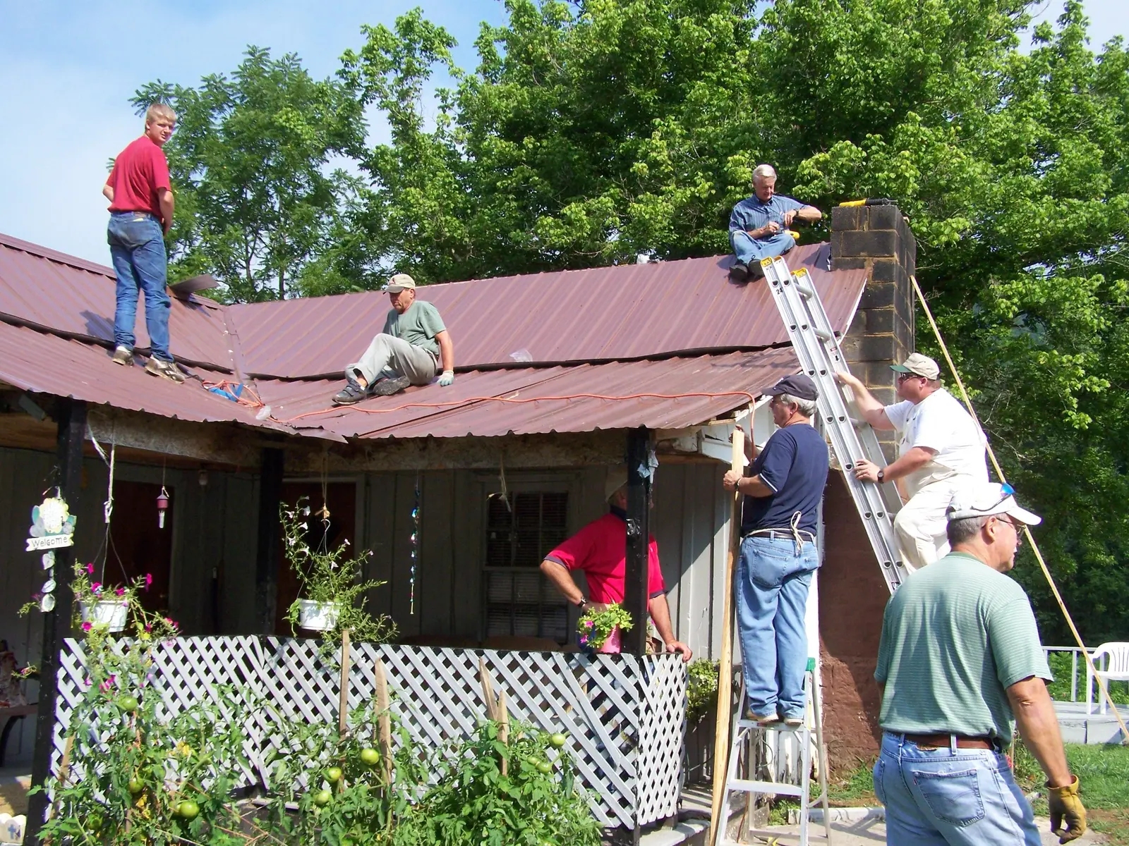Volunteers working together on a roof
